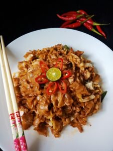 Char kuey teow being stir-fried in a hot wok at a George Town hawker stall