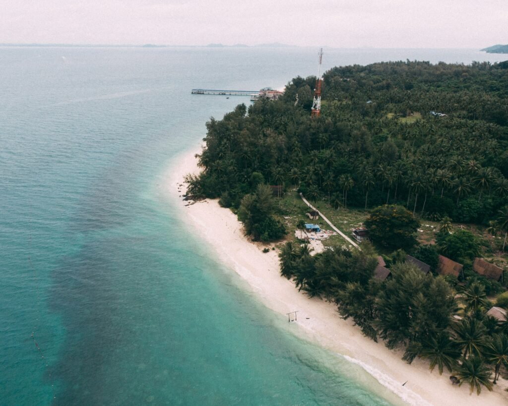 Crystal-clear water and white sand beach on Pulau Kapas, Malaysia, with few tourists around