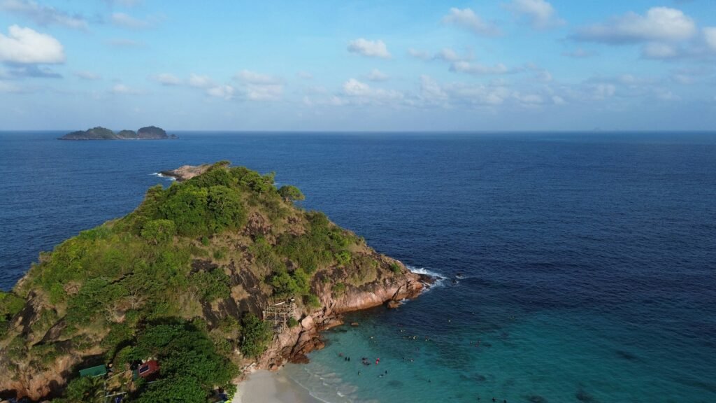Solo traveler snorkeling among colorful coral reefs and tropical fish near Pulau Perhentian Kecil, Malaysia.”