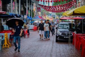 Busy night market in Kuala Lumpur’s Jalan Alor with street food stalls.
