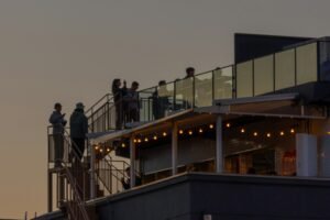 “Stunning night view of Kuala Lumpur city skyline from a rooftop bar.”