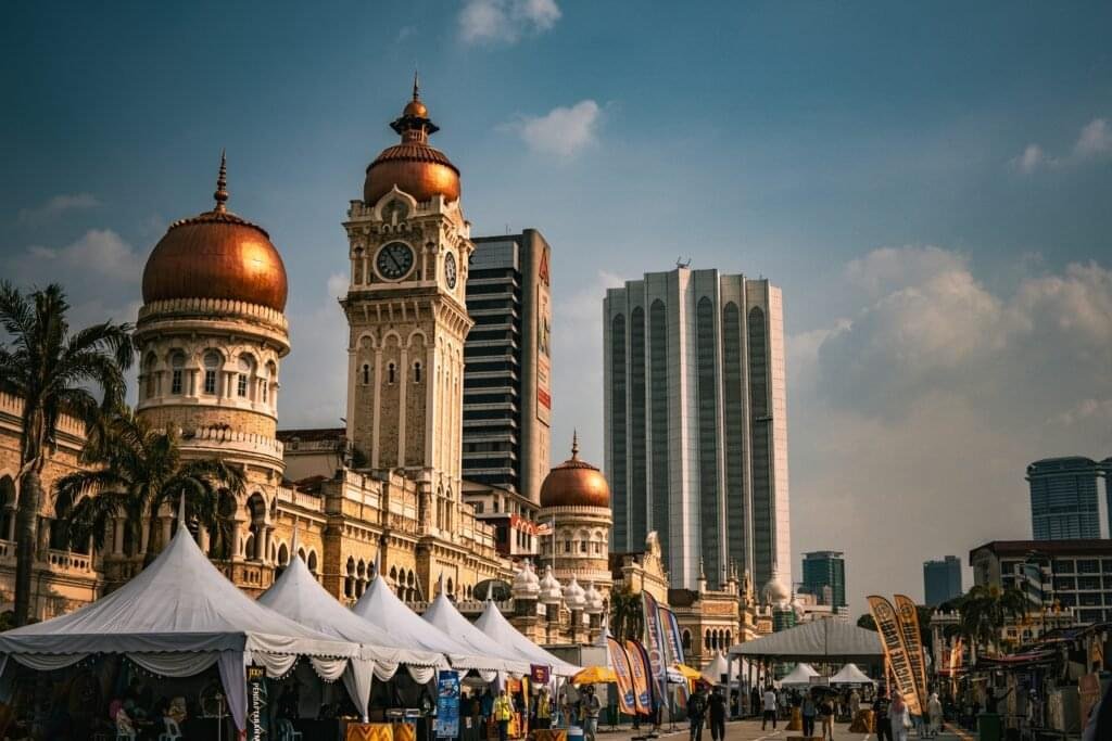 Colorful food stall at a Malaysian Ramadan bazaar selling traditional snacks and sweets